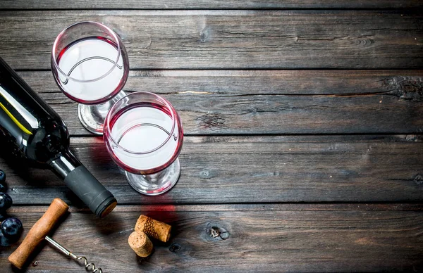 Wine background. Red wine in glasses with grapes.