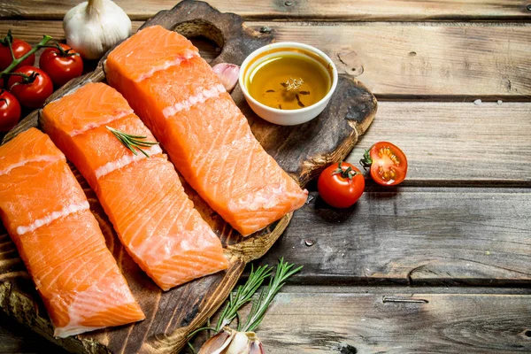 Raw salmon fish filet with tomatoes and spices.