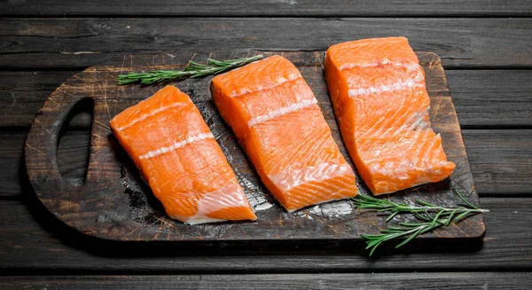 Raw salmon fish filet with rosemary.