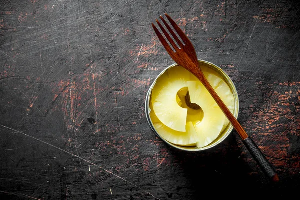 Canned pineapples in a tin can.