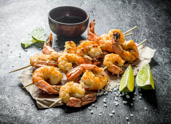 Delicious freshly cooked shrimps on skewers.