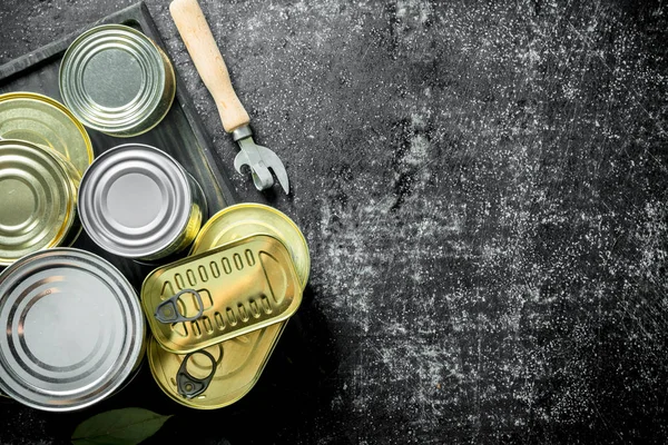 Tin cans of canned food on the cutting Board.