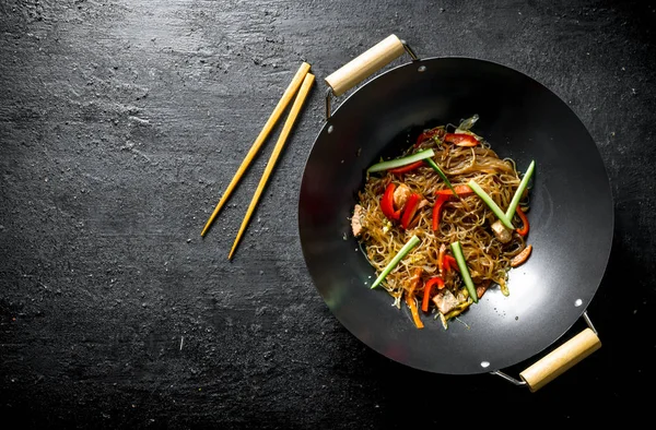 Chinese wok. Hot Asian cellophane noodles in a frying pan wok.
