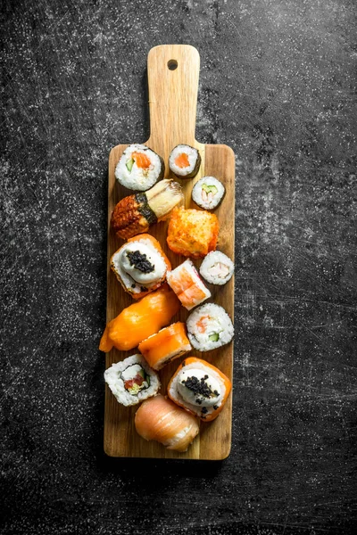 Freshly cooked sushi rolls on a cutting Board.