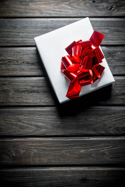 White Christmas box with red bow.