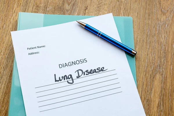 Lung disease diagnosis written on paper with a folder and pen.