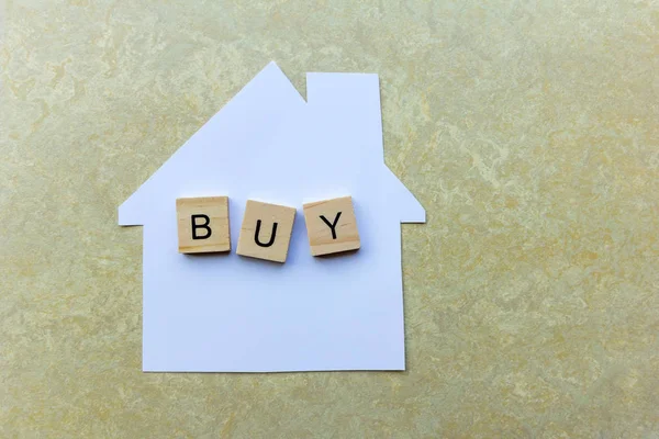 House Buying Concept - Paper house with the word \'Buy\'