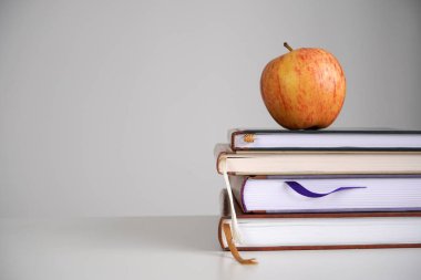 Okula dönüp, konsept çalışacağım. Kitapların üzerinde elma. Yakın plan, kopyalama alanı.