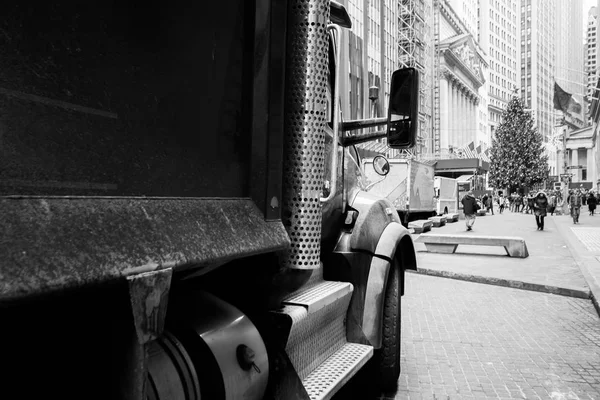 A big truck stands on Wall Street in New York. Black and white picture.