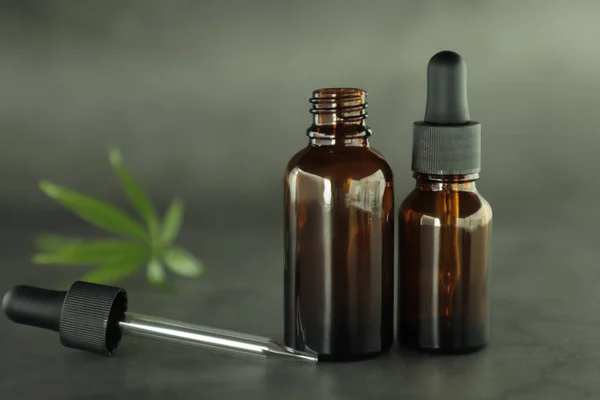 Dark Glass Bottles Full Cannabidiol Oil Hemp Leaves Dark Background — Stock Photo, Image