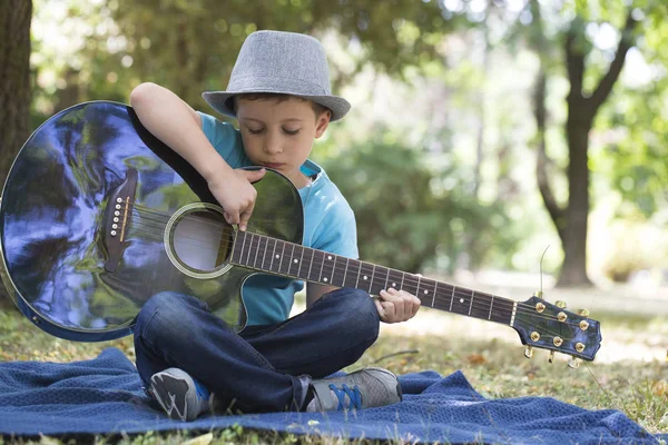 Portrait Little Sweet Boy Hat Sitting Park Playing Guitar Enjoying — Stock Photo, Image