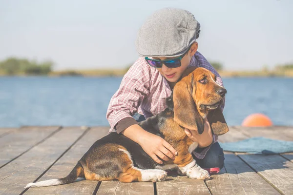 Little Cute Chłopiec Siedzi Nad Rzeką Psem Cieszą Się Razem — Zdjęcie stockowe