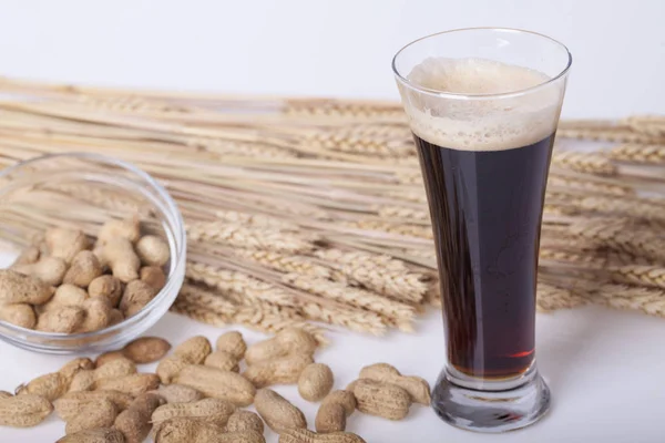 Black beer in the glass on the table, Selective focus and small depth of field