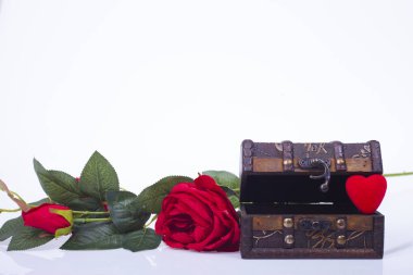 Bir ahşap kutu ve beyaz zemin üzerine kırmızı gül kırmızı kalp