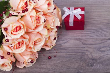 Güzel güller ve hediye kutusu ahşap arka plan üzerinde