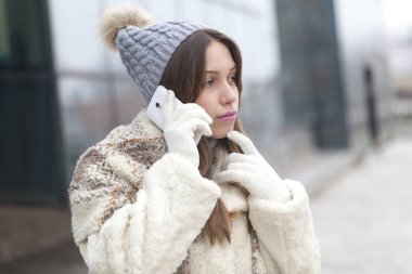 Genç kadın bir cep telefonu, seçici odak ve küçük alan derinliği ile telefon ederek