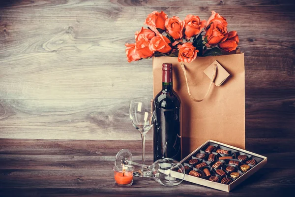 Red Wine Bottle Box Chocolates Roses Paper Bag Wooden Table — Stock Photo, Image