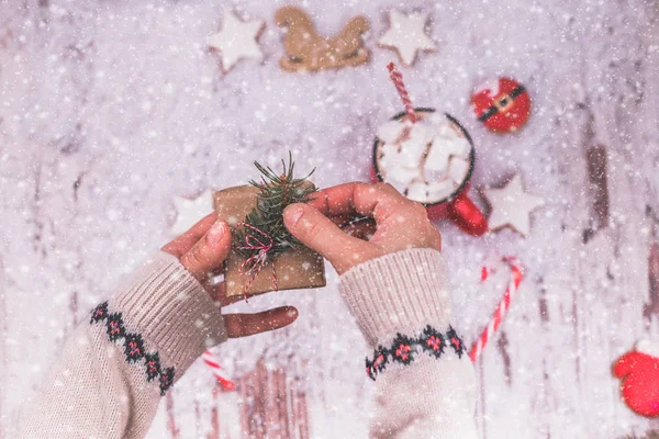 Woman hands wrap christmas holiday handmade present in craft paper with ribbon. Female hands holding a Christmas gift box. Christmas presents and New Year. Handmade.