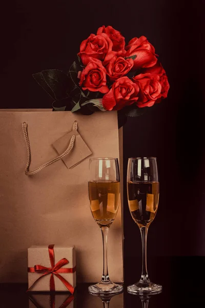 Champagne Bottle Paper Bag Two Wine Glasses Red Roses Black — Stock Photo, Image