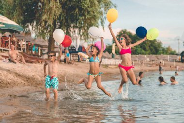 Mutlu çocuklar su balonlarla eğleniyor