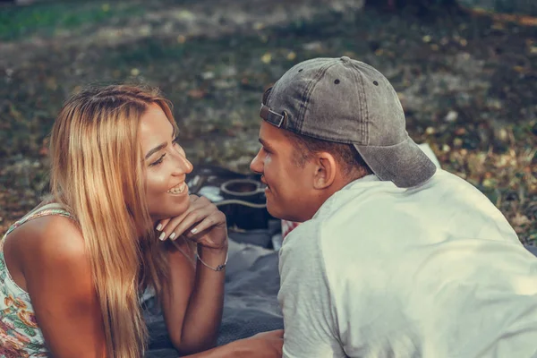 Joyeux jeune couple qui pique-nique dans le parc par une journée ensoleillée — Photo