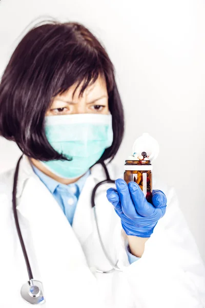 Doctor hands in medical gloves holding many different pills — Stock Photo, Image