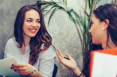 İki genç kadın konuşurken ve stra analiz ederken kahve içme