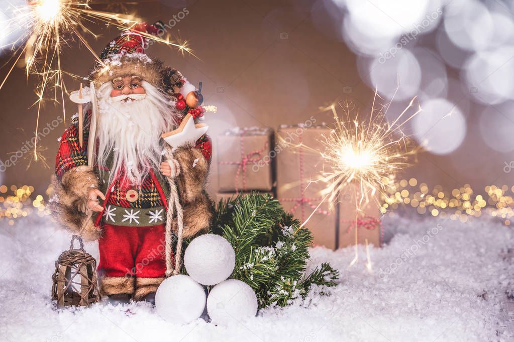 Santa Claus with fresh fir branches, sparklers and ornaments in 
