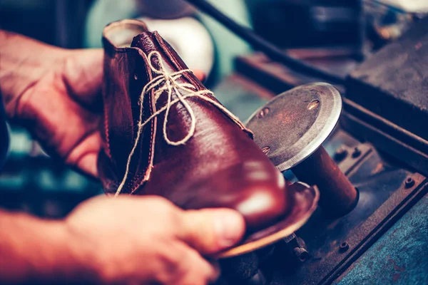 Experienced shoemaker using special machine tool for making a sh — Stock Photo, Image