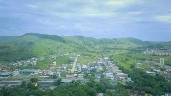 Beautiful aerial image of mountain and countryside with city in background