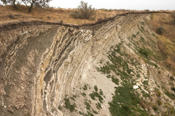 Layers of sedimentary rock formed on the earth's surface. Outcrops on the southern coast of the Azov sea. Taman Peninsula, Temryuk district, Krasnodar region, Russia