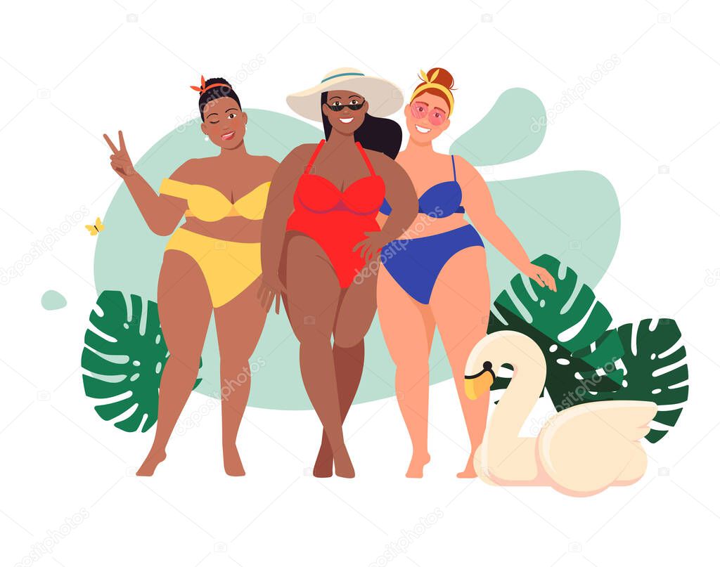 three multicultural women in swim suits standing at beach