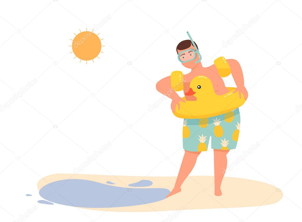 A man with a lifebuoy in oversleeves and a swimming mask touches the water with his foot.