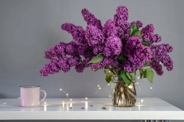 Bouquet Lilla Sul Tavolo Con Tazze Luci Festive — Foto Stock