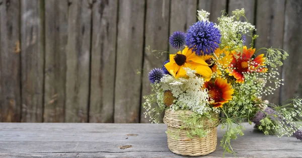 Bouquet of wildflowers on a rural background