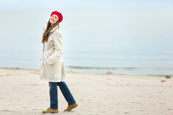 美しい女性の屋外の肖像画海の背景に秋の服を歩く — ストック写真