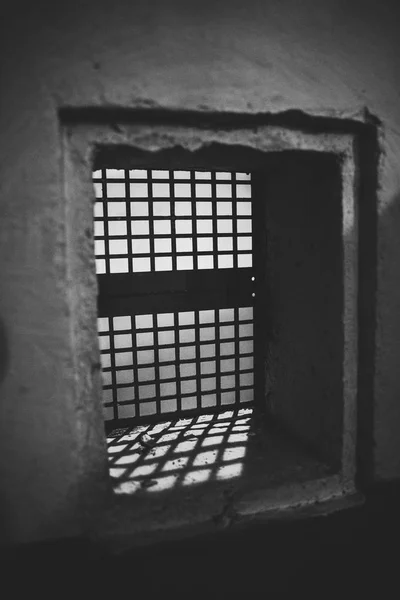 small window with bars in the old room