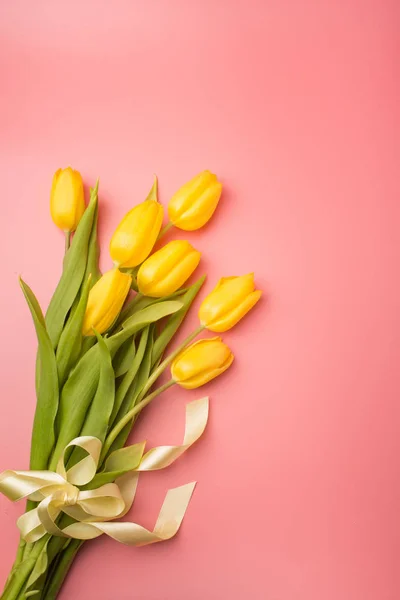 Spring card: yellow tulips on a coral background. Top view, lay flat — Stock Photo, Image