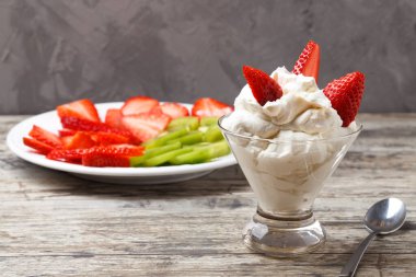 Çilekli bir fincanda krema..