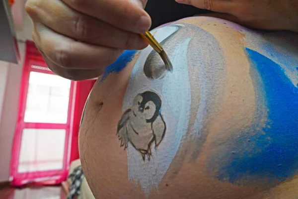 Belly painting on a pregnant woman.