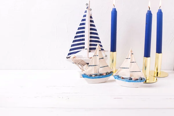 Decorative Wooden Toy Boats Blue Burning Candles White Textured Background — Stock Photo, Image