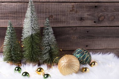 winter holidays set with decorative fir trees on wooden background
