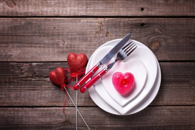 Tablo ayarı beyaz yemek takımı ve çatal bıçak takımı ile üstten görünüm ahşap masa üzerinde