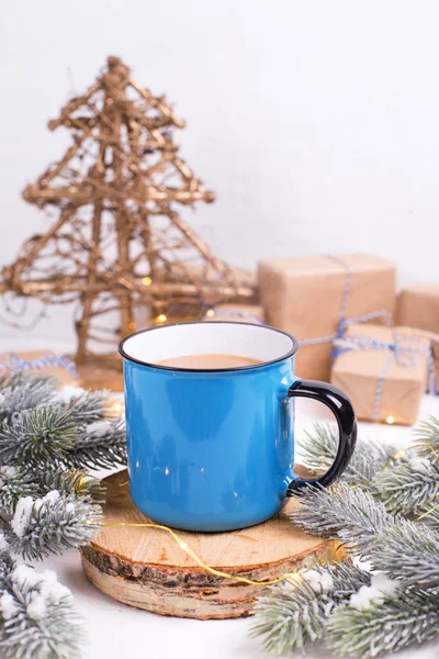 close up view of blue mug with winter decorations on white background