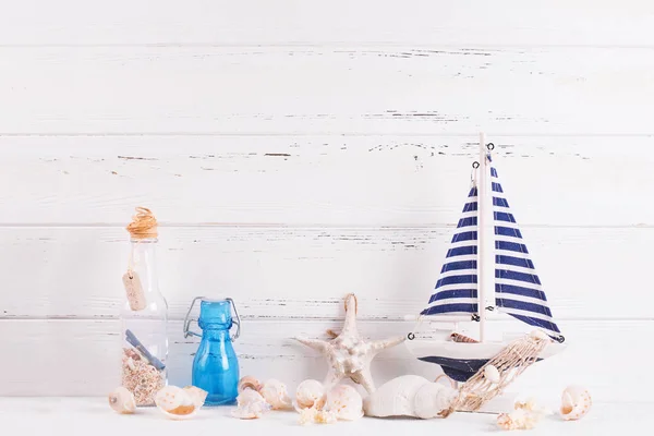 Marine decorations near by wooden white  wall.