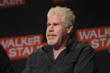 MANNHEIM, GERMANY - MAR 17th 2018: Ron Perlman (*1950, actor, Hellboy, Sons of Anarchy, Blade II) talks about his experiences in Sons of Anarchy at Walker Stalker Germany clipart