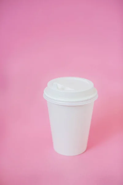 Cup of coffee to go on a pastel background.