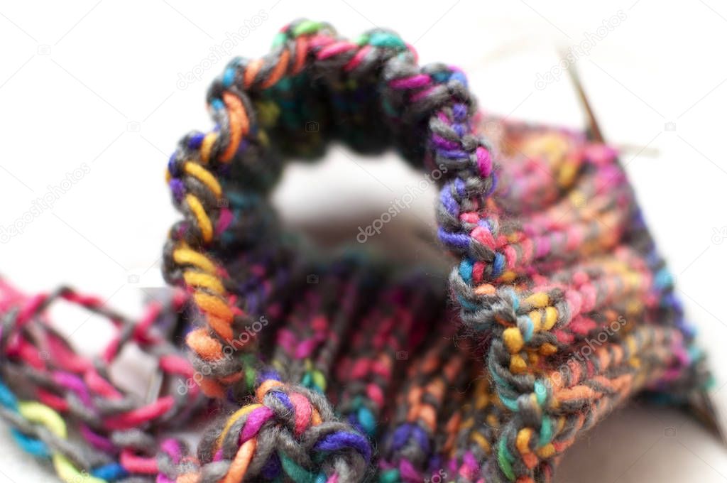 Socks knitting close-up, bright colorful yarn and needles 