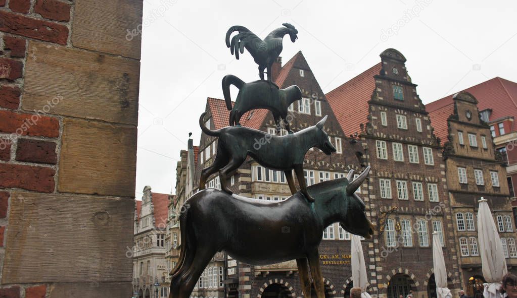 Bronze statue of the Town Musicians of Bremen in old city centre, beautiful houses on the background, Bremen, Germany