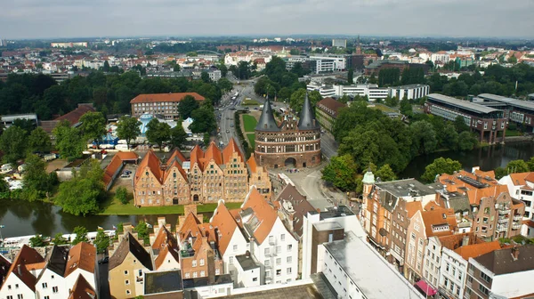 Aerial scenic view of Holsten Gate or Holstentor and Salzspeicher warehouses in old town, beautiful architecture, sunny day, Lubeck, Germany